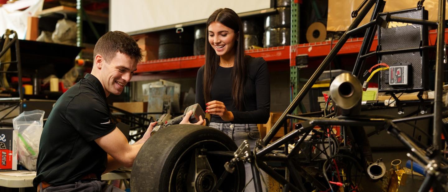 Two students working in a mechanical lab.