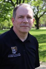 A professional headshot of Steve Szalay in a black Oakland University shirt.